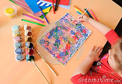 Child painting abstract with flowers and smiles, hello summer, Children development . The concept of a happy childhood and happy Stock Photo