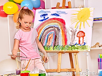 Child painting at easel Stock Photo