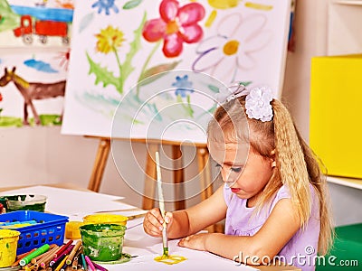 Child painting at easel Stock Photo