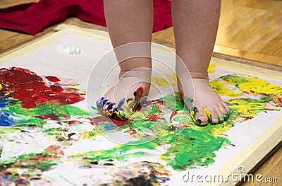 Child painting by feet Stock Photo