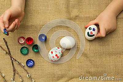 The child paints eggs for Easter Stock Photo