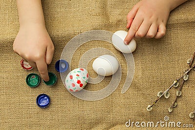 The child paints eggs for Easter Stock Photo