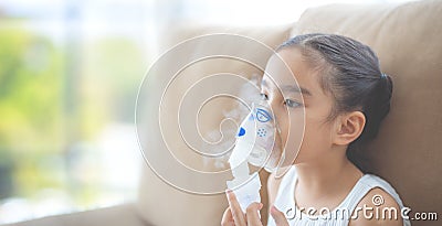 Child patient inhalation therapy by the mask of inhaler with soft stream smoke from bronchodilator. Stock Photo