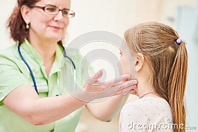 Child pediatrician. Female doctor palpating for diagnosing a disease Stock Photo