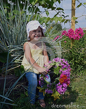 Child person flowers happy young people cute meadow pretty childhood garden flower outdoors nature gardening beauty summer green Stock Photo