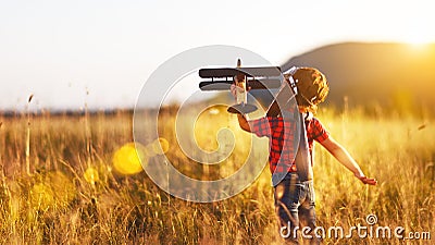 Child pilot aviator with airplane dreams of traveling in summer Stock Photo