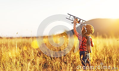 Child pilot aviator with airplane dreams of traveling in summer Stock Photo