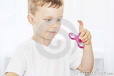 Child play with fidget spinner stress relieving popular toy Stock Photo