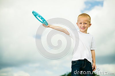 Child in playground kid in action boy playing with frisbee Stock Photo