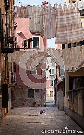 Child playing alone in venice - the other side of Venice - Italy Editorial Stock Photo