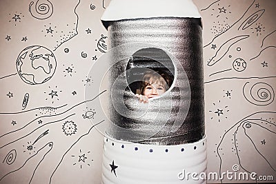 Child playing with big hand made rocket. Stock Photo