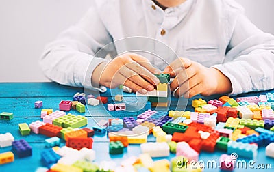 Child playing and building with colorful toy bricks, plastic blocks Stock Photo