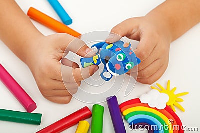 Child playing with colorful clay - closeup on hands Stock Photo