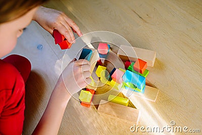 child playing with colorful wooden blocks Stock Photo