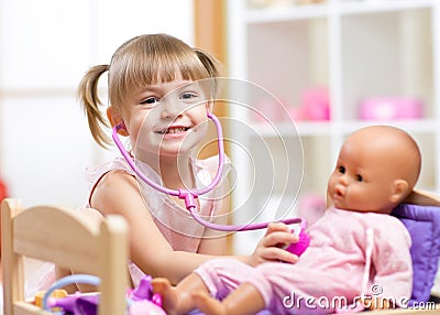 Child playing doctor role game examinating her Stock Photo