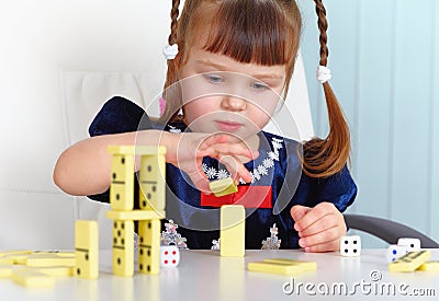 Child playing with dominoes Stock Photo