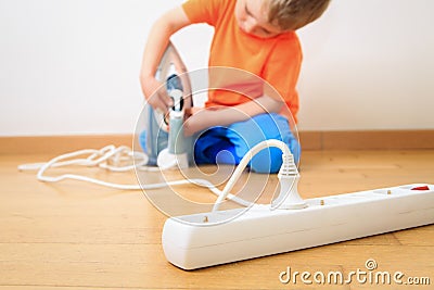 Child playing with electricity, kids safety Stock Photo