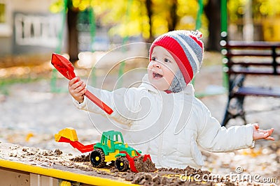 Child playing excavator on the street Stock Photo