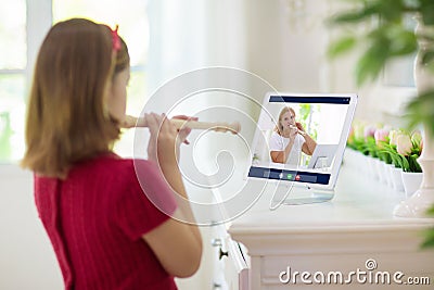 Child playing flute. Remote learning Stock Photo