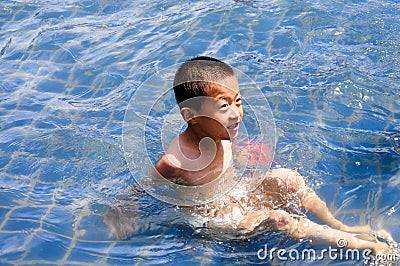 A child is playing happily in the water Stock Photo