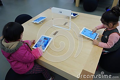 Child playing ipad Editorial Stock Photo