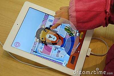 Child playing ipad Editorial Stock Photo