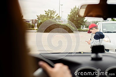 Child playing mobile games on smartphone on the street Stock Photo