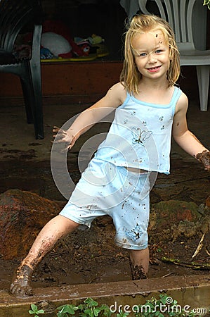 Child playing in mud Stock Photo