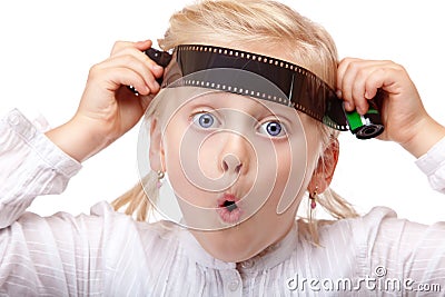 Child playing with old analog camera film Stock Photo