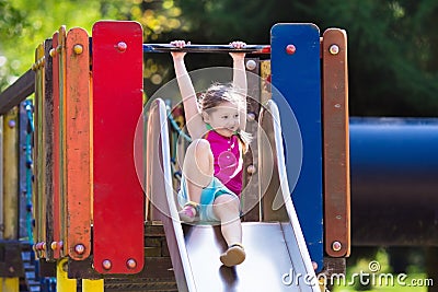 Child playing on outdoor playground in summer Stock Photo