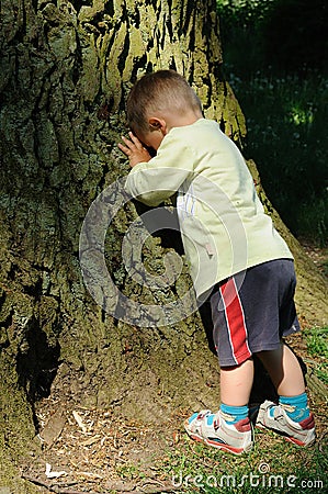 Child playing peek-a-boo Stock Photo