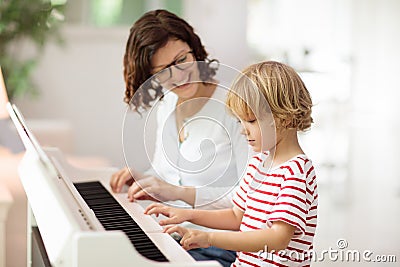 Child playing piano. Kids play music Stock Photo