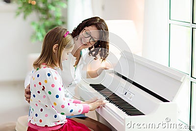 Child playing piano. Kids play music Stock Photo