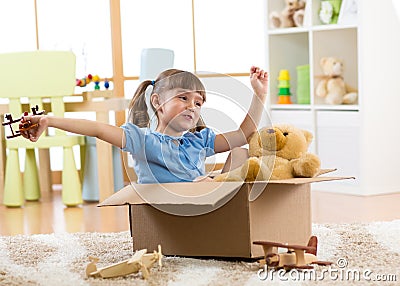 Child playing with plane toy at home. Travel, freedom and imagination concept. Stock Photo