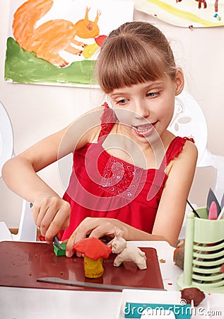 Child playing with plasticine in school. Stock Photo