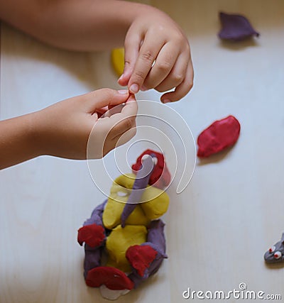 Child playing with play dough Stock Photo