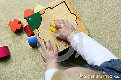 Child playing with shape sorter Stock Photo