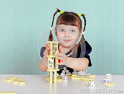 Child playing with small toys at table Stock Photo