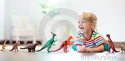 Child playing with toy dinosaurs. Kids toys Stock Photo