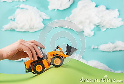 Child playing with a toy truck in handmade world Stock Photo