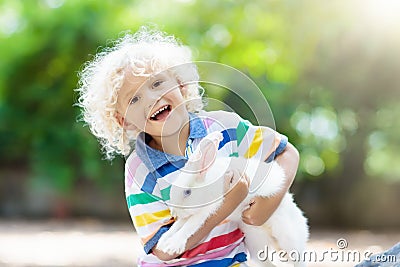 Child with rabbit. Easter bunny. Kids and pets. Stock Photo