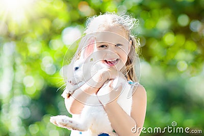 Child with rabbit. Easter bunny. Kids and pets. Stock Photo