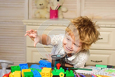 Child in playroom. Kids face, little boy playing with colorful blocks, portrait. Stock Photo