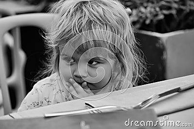 Child pondered. Baby boy in outdoor cafe Stock Photo