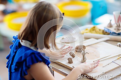 Child at pottery wheel. Kids arts and crafts class Stock Photo