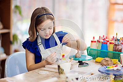 Child at pottery wheel. Kids arts and crafts class Stock Photo