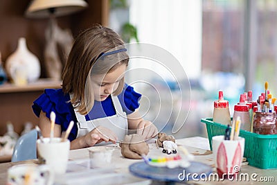 Child at pottery wheel. Kids arts and crafts class Stock Photo