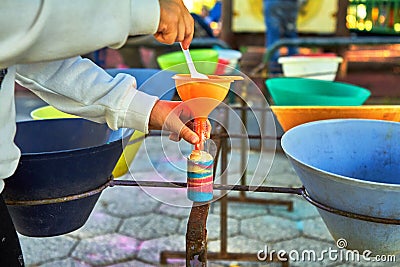 Child pour colored sand in the bottle Stock Photo