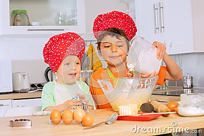 Child pour flour to the mix bowl cooking cookies Stock Photo