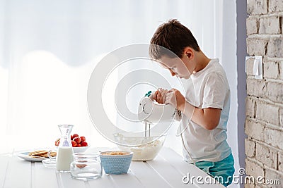 Child preparing cookies in kitchen Stock Photo